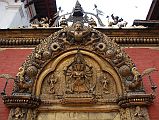 Kathmandu Bhaktapur 04-2 Bhaktapur Durbar Square Golden Gate Torana With Garuda And Taleju Bhawani A garuda tops the torana, disposing of a number of serpents, at the Golden Gate in Bhaktapurs Durbar Square. The four-headed and 10-armed figure of the goddess Taleju Bhawani is directly above the door.